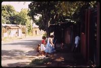 Women and children approaching doorway in Managua