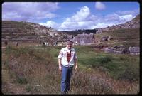 Jack Child standing in field near Sacsahuayman hills