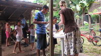 Rachel Teter and children put marshmallows on cookies for s'mores, El Plátano, Panama