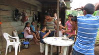 Women and children stand around a table enjoying s'mores, El Plátano, Panama
