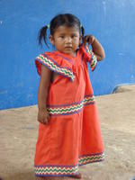 A Ngöbe girl in a red dress at la Comarca de Ngöbe-Buglé, Panama 