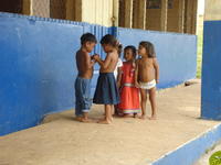 Ngöbe children stand outside of building, la Comarca de Ngöbe-Buglé, Panama 