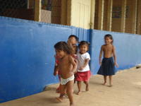 Ngöbe children run together outside, la Comarca de Ngöbe-Buglé, Panama 
