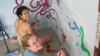 Rachel Teter and another volunteer work on the mural at the new library, El Plátano, Panama