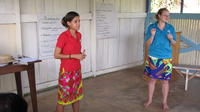 Female Peace Corps Volunteer in red and Rachel Teter at an agribusiness seminar in Bocas del Toro, Panama