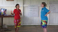 Female Peace Corps Volunteer in red talking with Rachel Teter at an agribusiness seminar in Bocas del Toro, Panama