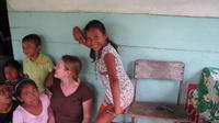 Rachel Teter and her neighbors pose for a picture while reading a book, El Plátano, Panama