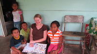 Rachel Teter and her neighbors pose together with a children's book, El Plátano, Panama
