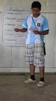 Alternate view of a man wearing a jersey addressing others at an agribusiness seminar in Bocas del Toro, Panama
