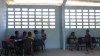 Two groups of children play cards at the new library in El Plátano, Panama