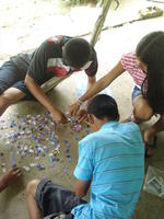 Aerial view of children putting together a puzzle at Raquel's house in El Plátano, Panama