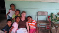 Rachel Teter reads with her neighbors on her porch in El Plátano, Panama