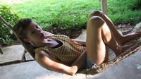 A young woman rests in a hammock in El Plátano, Panama