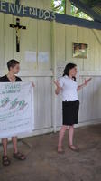 Two women talking about nurseries at an agribusiness seminar in Bocas del Toro, Panama