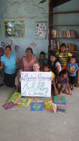 Rachel Teter and others hold a thank you sign for donors contributing to the new library, El Plátano, Panama