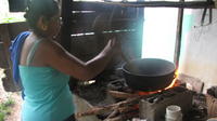 Elvira stirs roasting coffee in El Plátano, Panama 