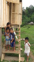 Children stand on the steps of a building while Rachel Teter visits Bocas del Toro, Panama
