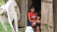 Family members sitting in their home, Bocas del Toro, Panama