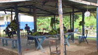 People sitting in an outdoor classroom for a school fundraiser, El Plátano, Panama