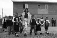 Peace Corps Volunteer Amanda Herrera walking hand-in-hand with a group of Mapuche children going to the opening of the Internado Centro Cultural Mapuche, Temuco, Chile