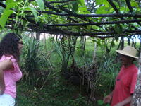 Woman speaks to a man under tree branches in El Barrigón, Panama