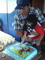 Boy cutting the cake at his birthday party, El Plátano, Panama