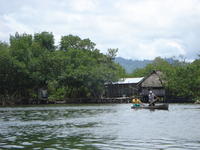 Men paddling a canoe, Bocas del Toro, Panama