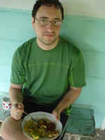 Man eating egg and potato breakfast on Rachel Teter's porch, El Plátano, Panama 