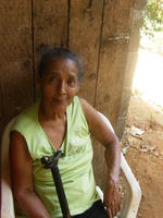 Close up of Abuela Chiru sitting in a chair with walking cane in El Plátano, Panama
