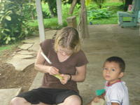 Boy holds totuma half, or calabash gourd, while Rachel Teter is carving the other half, El Plátano, Panama