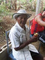 Abuelo Santo sitting in chair with beverage celebrating his 93rd birthday in El Plátano, Panama
