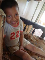 Child poses on couch, El Plátano, Panama