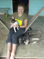 Alternate view of Rachel Teter posing in a hammock with a cat and dog, El Plátano, Panama