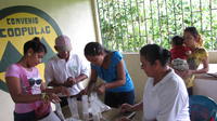 People participating in Cooperativa Pueblos Unidos de Lago Gatún (COOPULAG) agriculture-business workshop in Guabo, Panama
