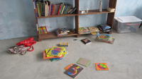 Books and toys lay on the floor of the community library,  El Plátano, Panama