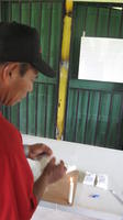 Man with cap participating in Cooperativa Pueblos Unidos de Lago Gatún (COOPULAG) agriculture-business workshop in Guabo, Panama