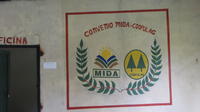 Agriculture-business workshop, Cooperativa Pueblos Unidos de Lago Gatún (COOPULAG) banner painted on wall in Guabo, Panama
