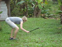 Rachel Teter cuts grass with a machete in El Plátano, Panama