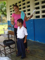 Boy speaking into a microphone at the patronage festival in El Plátano, Panama