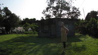 Laura stands outside of her home in Panama