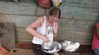 Rachel Teter grates yuca into a bowl to make enyucado, El Plátano, Panama