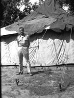 First Lt. Myers in front of a tent, Camp Kanchrapara (Winter 1946) (2)