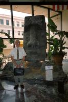 Man posing in front of Moai head at Yugo Next exhibition in Union Station, Washington, D.C.