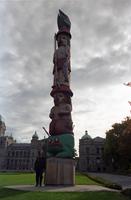 Full view of Iona Striner and totem pole outside the British Columbia Parliament Buildings, Victoria, British Columbia