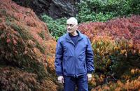 Herb Striner posing in front of Japanese maples in the Japanese Garden in Butchart Gardens, Victoria, British Columbia