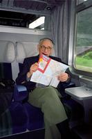 Herb Striner looking at a map on a train, Italy