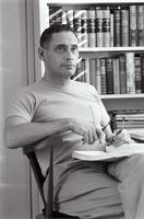 Herb Striner sitting in chair with a book