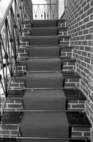 Exterior brick staircase with carpet runner 