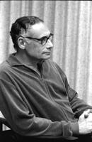 Alternate portrait of seated Herb Striner wearing glasses