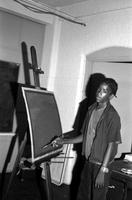 Young man painting at an easel